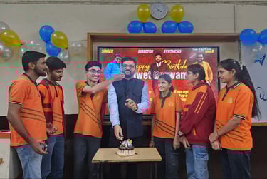 Mentor celebrating birthday with students in a decorated classroom.