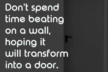 Inspirational quote about transformation and walls becoming doors with an image of a dark room and exit sign.