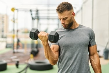 a young man curling a dumbbell