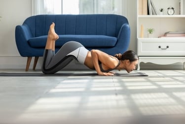 A fit woman practicing yoga on a mat in a bright living room doing a modified push-up pose.