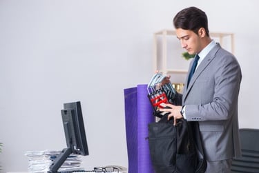 Businessman packing fitness equipment and a yoga mat into a bag for a workout after office work.