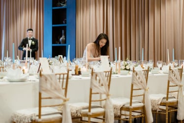 a woman is sitting at a table with candles and candles