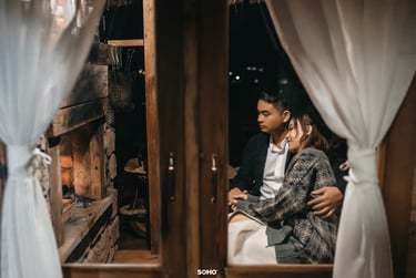 a man and woman sitting on a couch in a room