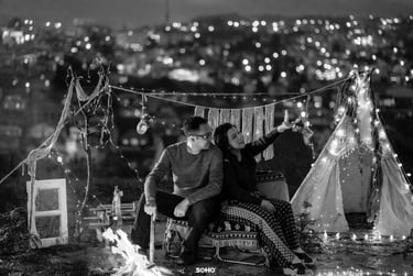 a couple sitting on a bench in a tent
