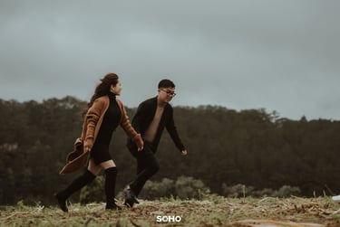 a man and woman walking in the grass