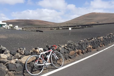 a bicycle parked next to a stone wall