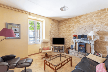 a living room with a fireplace and a stone fireplace