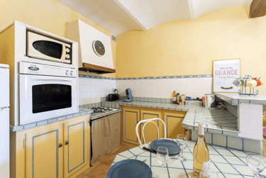 a kitchen with a table and chairs and a microwave