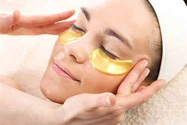a woman with a gold eye mask on her face