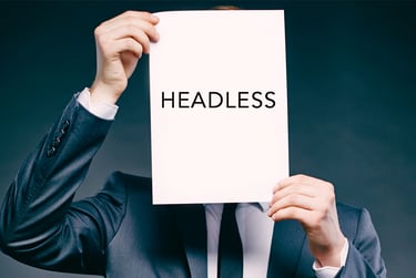 image of man holding piece of paper with "headless" written upon it