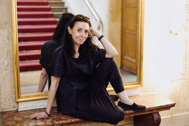 A portrait of Shermin Langhoff photographed in a theatre lobby.