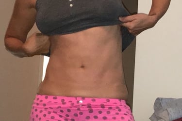 a woman in a pink polka dotty shortsuit and a black tank top