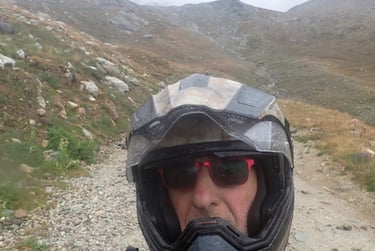 a man in a helmet and a helmet on a motorcycle