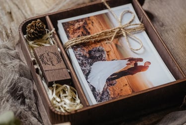 Custom wooden wedding photo box with engraved USB drive and prints tied in twine.