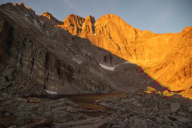 Longs Peak and chasm Lake glow brilliantly during summer sunrise