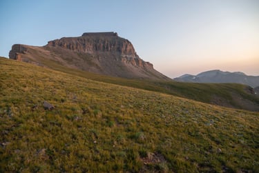  Uncompahgre Peak, the alpine tundra, and distant surrounding peaks aglow during summer sunrise
