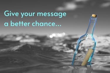 On-hold Message in a coloured bottle bobbing in a greyscale ocean