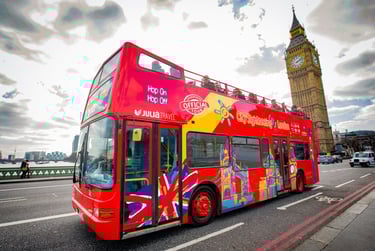 Red open-top double-decker bus in London with Big Ben in the background