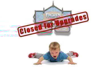 Crying toddler lying on floor below a Frozen Ever After sign with a red "Closed for Upgrades" stamp.