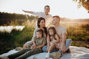 large caucasian family having picnic at sunset