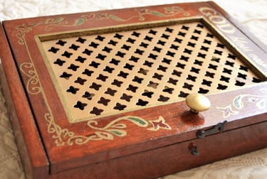 a wooden box with a golden handle