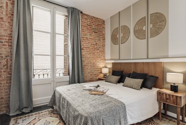 Relaxing bedroom with natural wood finishes, neutral tones, and minimalist design in Barcelona