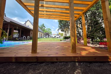 a wooden deck with a pool and a pool