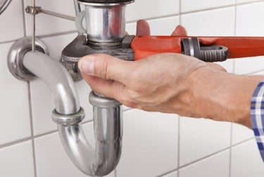 Suasana Plumbing services installing new sink pipes and fixing leaks.