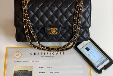 a black Chanel handbag with original documentation and certificate of authenticity