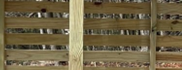 a chord of chopped wood logs stacked on top of each other in a wooden storage shed in MA