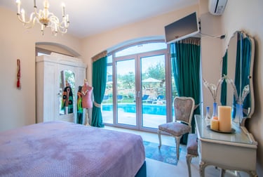 a bedroom with a queen size bed and a pool view