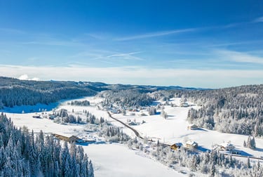 a person on a ski slope with a view of a mountain