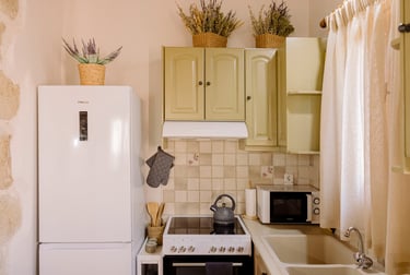 A kitchen with a refrigerator, microwave, and oven | Tonia's Cottage