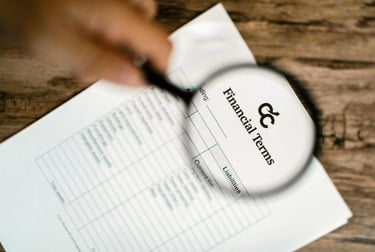 A maginfying glass hovering over a piece of paper with the and the words 'Financial Terms'