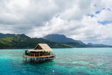 tahitian landscape with house on stilts over turquoise water