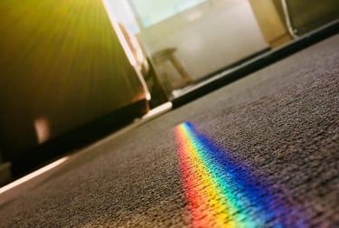 a rainbow - colored rainbow - colored light shining through a rainbow - colored light