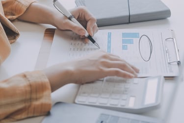 A photo showing the hands of an administrator holding a pencil examining documents