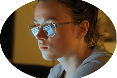 a woman in glasses and a gray shirt