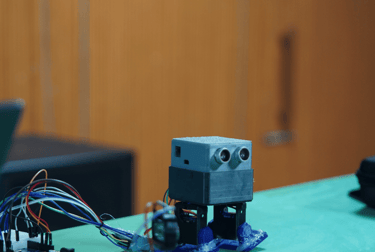 a robot robot with a laptop on a table