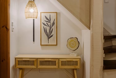 A rattan console table with a unique decoration and a beautiful lamp