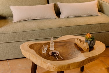 A couch with wooden table and Cretan raki