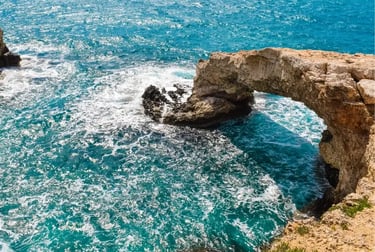 Natural stone bridge arch over turquoise Mediterranean sea water in Ayia Napa, Cyprus.