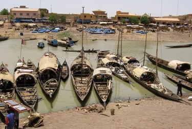 Traditional pinasse boats docked at the port of Mopti along the Niger River in Mali.