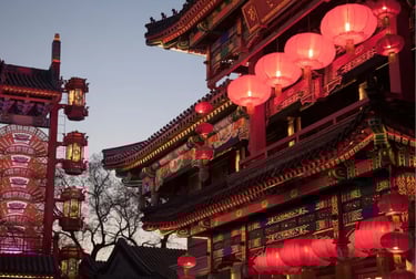 Illuminated red Chinese lanterns hanging from a traditional pagoda at dusk during Lunar New Year.