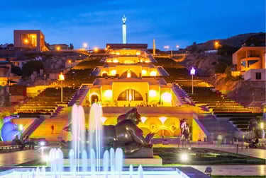 Illuminated Cascade Complex in Yerevan Armenia at night with fountains and statues.
