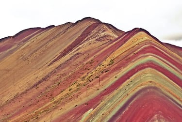 The vibrant mineral layers of Vinicunca Rainbow Mountain in the Andes of Peru.