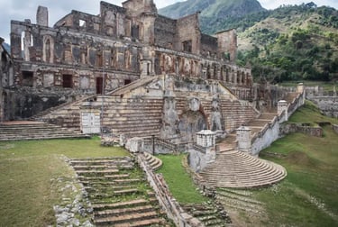 Historic stone ruins of Sans-Souci Palace with grand staircases in Milot, Haiti.