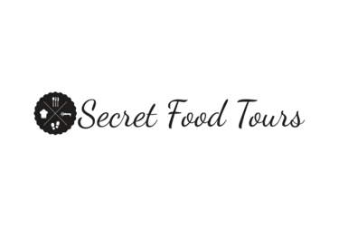 Secret Food Tours logo featuring a circular icon with culinary symbols on a black background.
