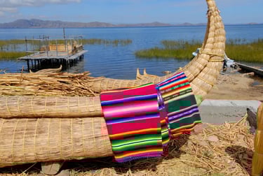 Traditional Peruvian reed boat with colorful woven textiles on Lake Titicaca.