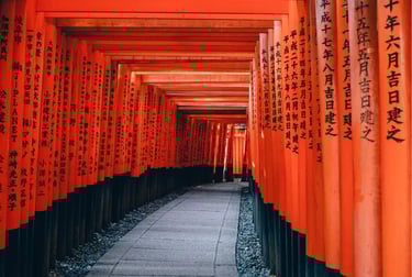 Pathway through iconic vermilion torii gates at Fushimi Inari Shrine in Kyoto, Japan.